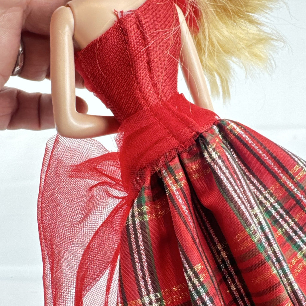 Mattel 2023 Holiday Barbie doll with blonde hair wearing a one-shoulder red plaid and tulle ballgown