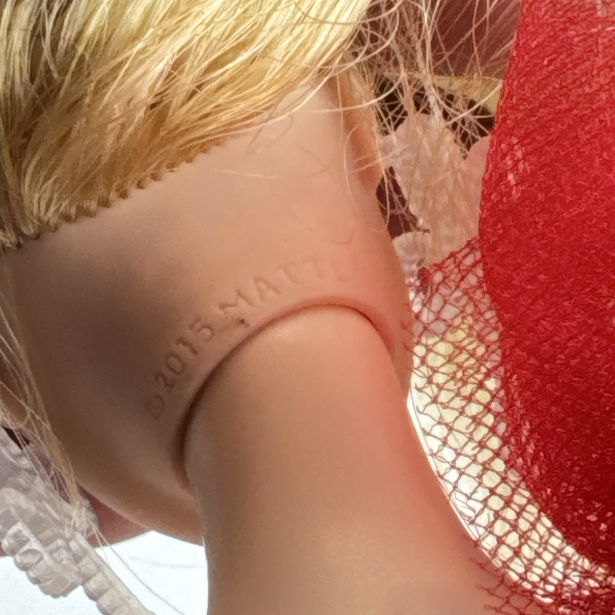 2024 Mattel Holiday Barbie doll wearing an asymmetrical red tartan plaid ball gown with tulle accent