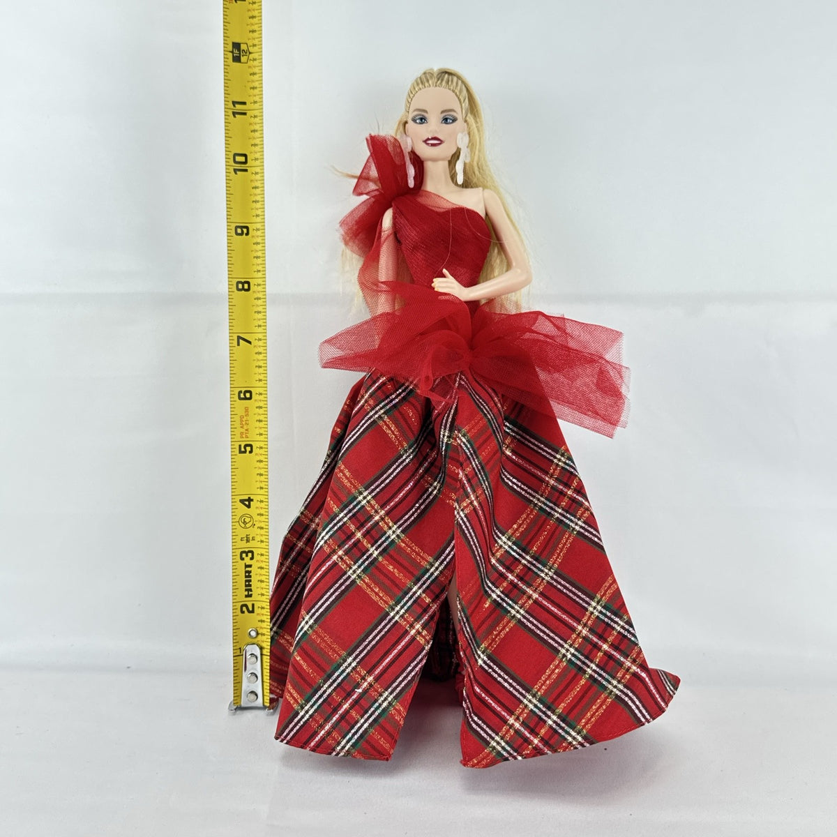 2024 Mattel Holiday Barbie doll wearing an asymmetrical red tartan plaid ball gown with tulle accent