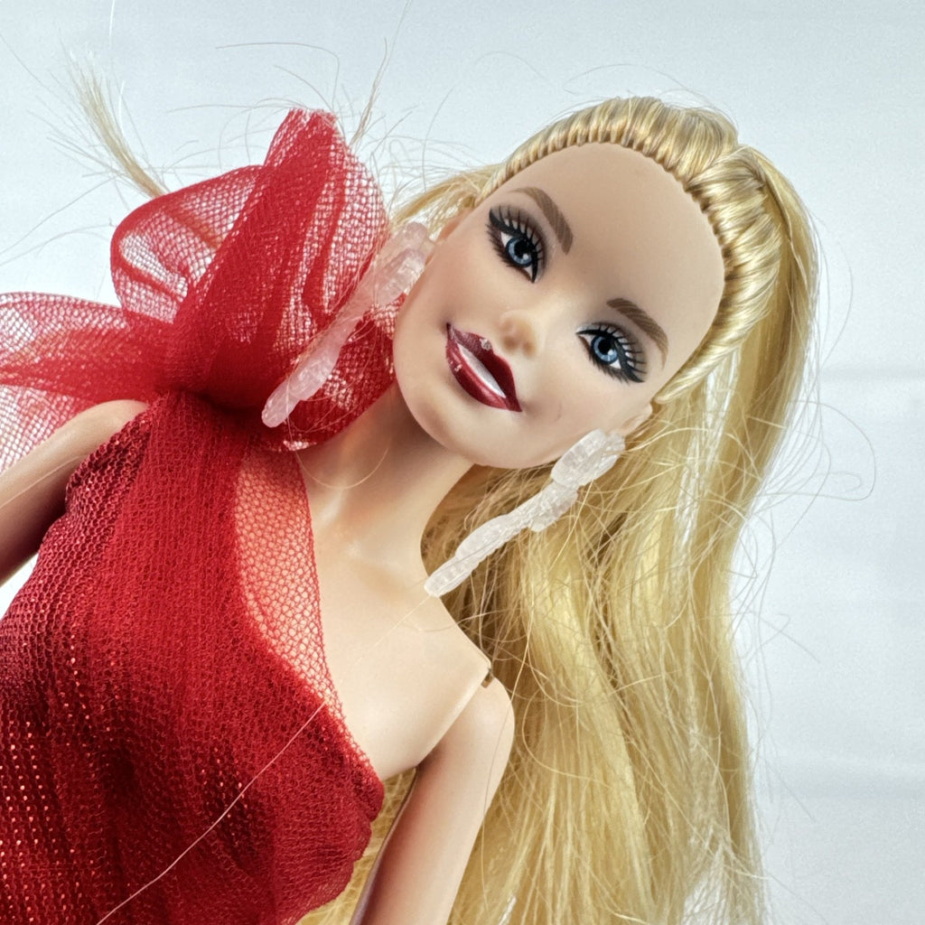 2024 Mattel Holiday Barbie doll wearing an asymmetrical red tartan plaid ball gown with tulle accent