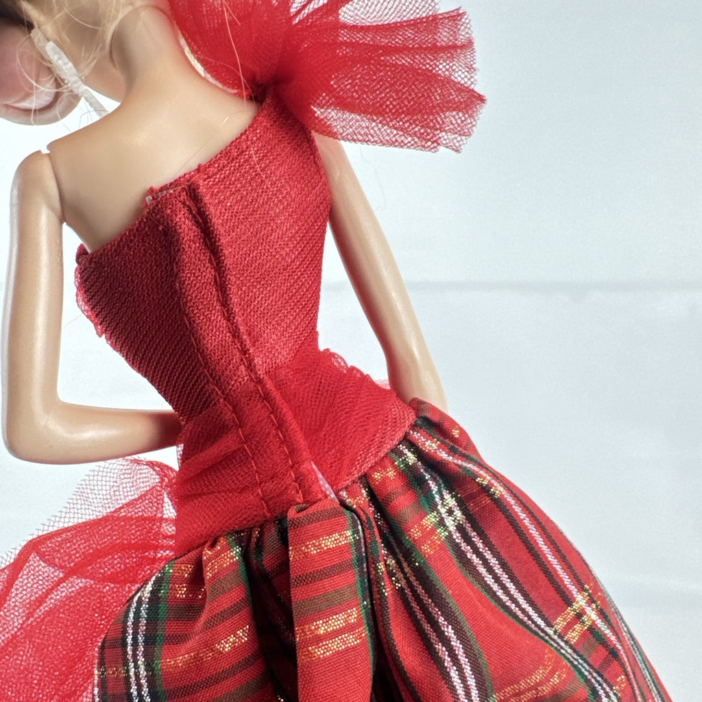 2024 Mattel Holiday Barbie doll wearing an asymmetrical red tartan plaid ball gown with tulle accent