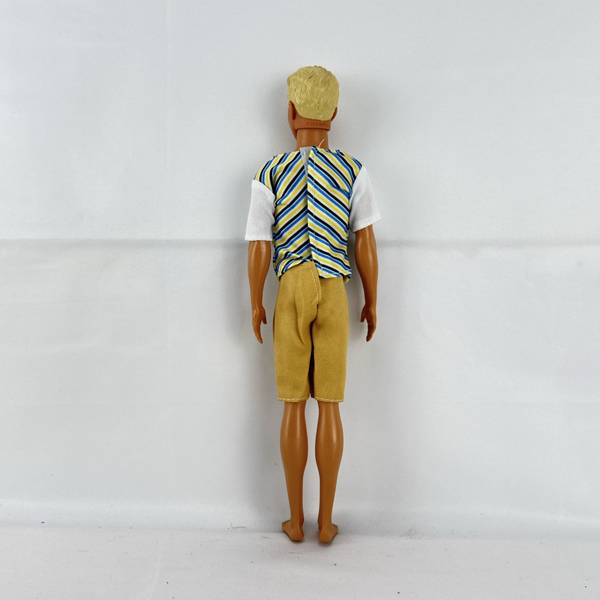 Mattel 2016 Ken doll with molded blonde hair in striped t-shirt and yellow shorts