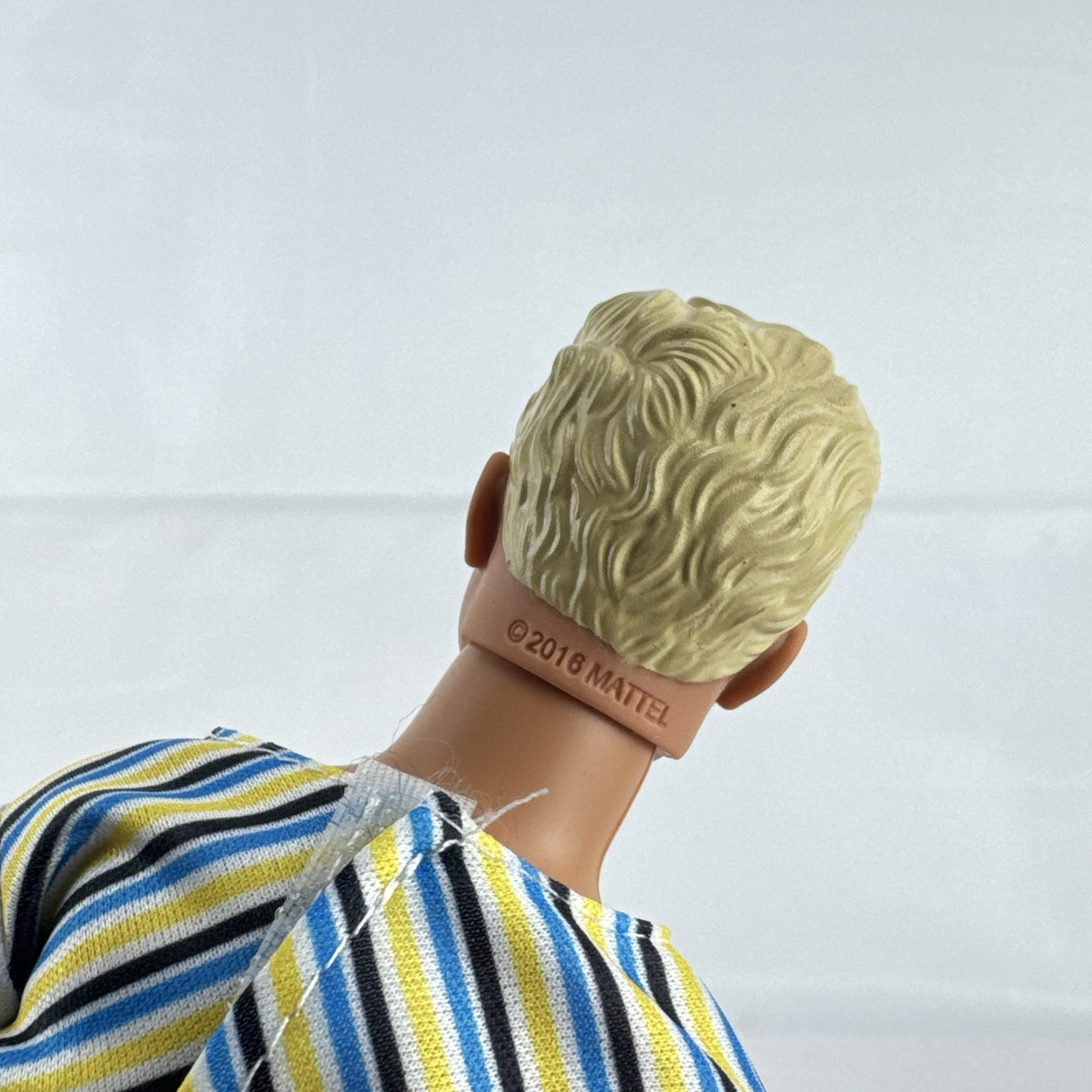 Mattel 2016 Ken doll with molded blonde hair in striped t-shirt and yellow shorts