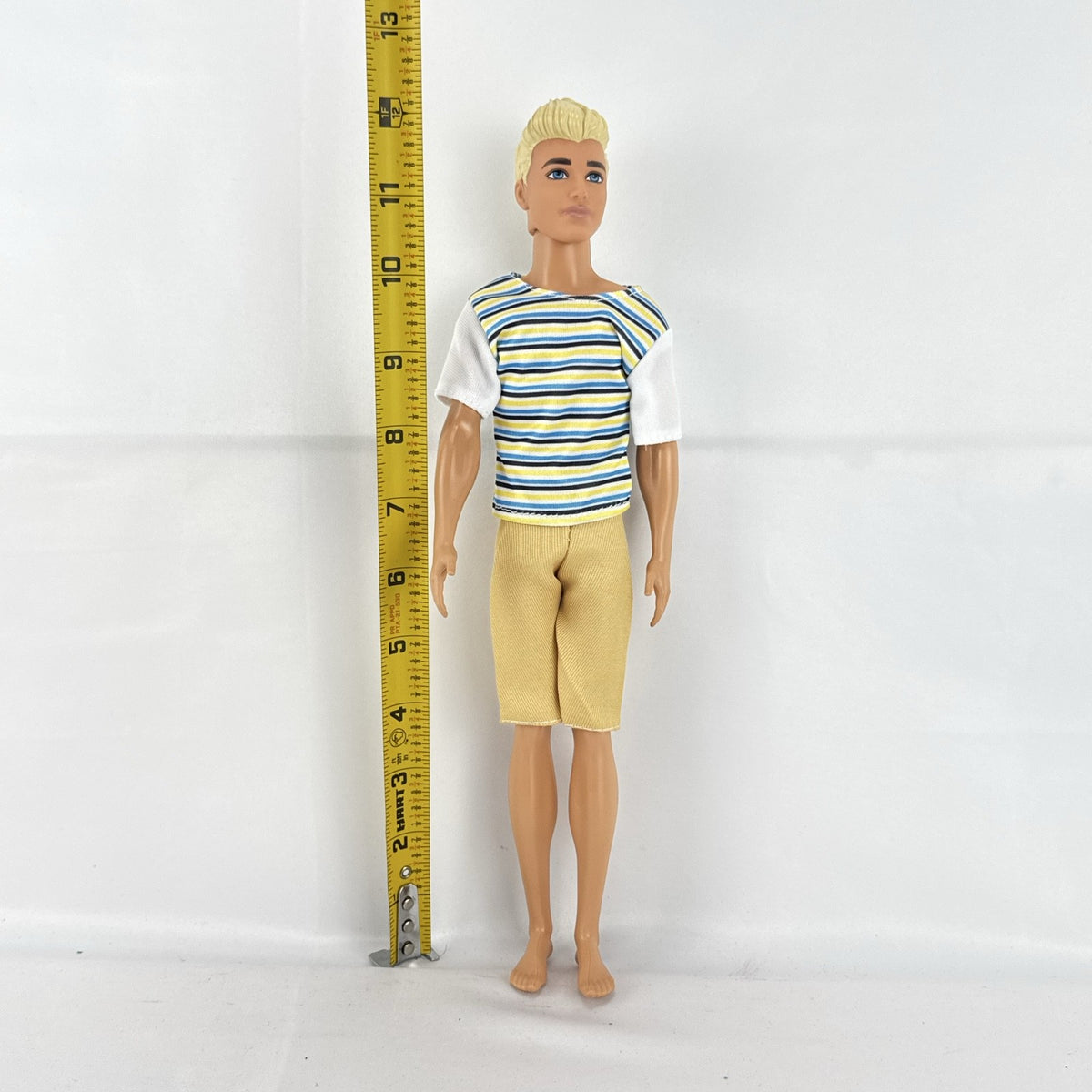 Mattel 2016 Ken doll with molded blonde hair in striped t-shirt and yellow shorts