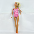 1998 Mattel Barbie doll with blonde side ponytail, celestial star swimsuit, and orange heels