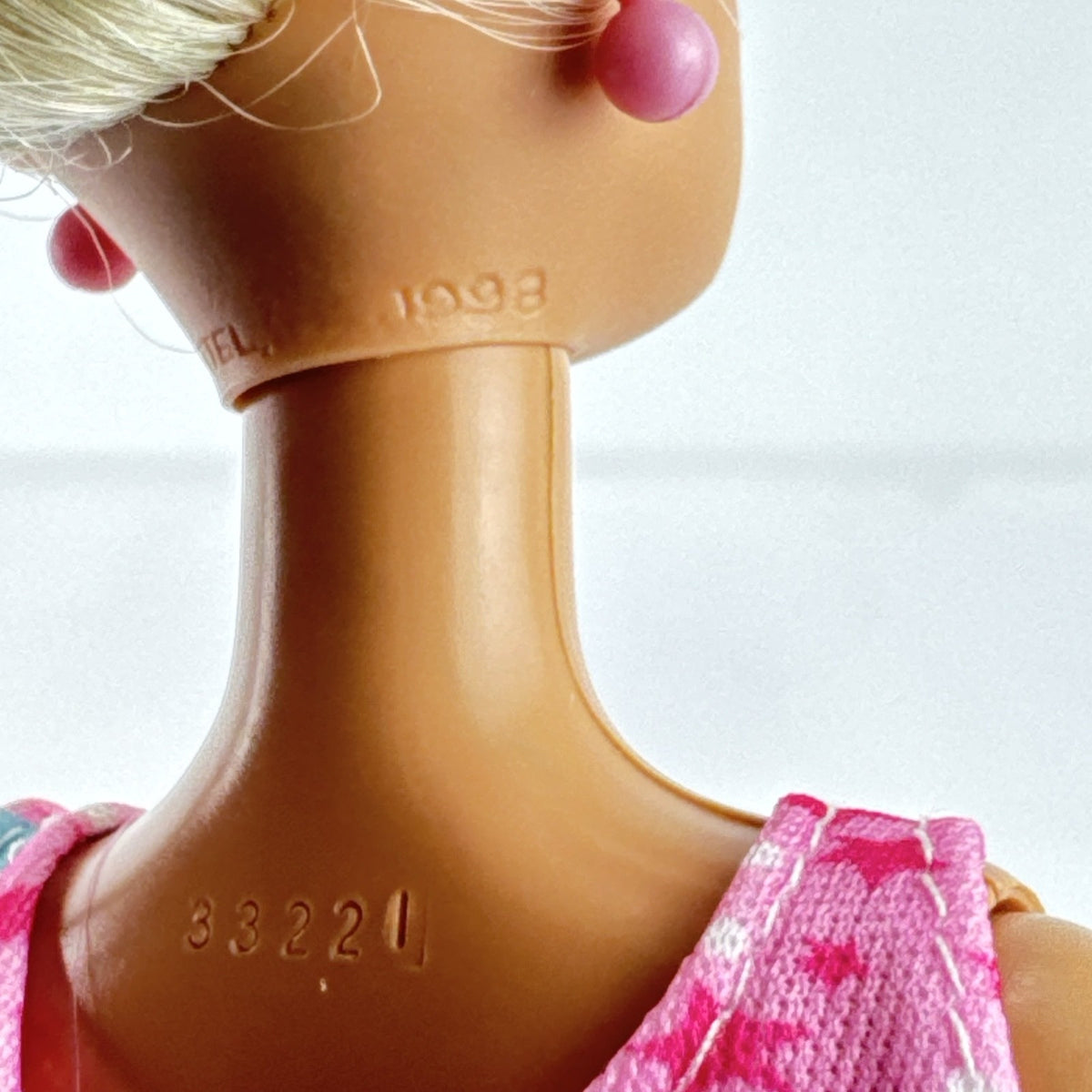 1998 Mattel Barbie doll with blonde side ponytail, celestial star swimsuit, and orange heels