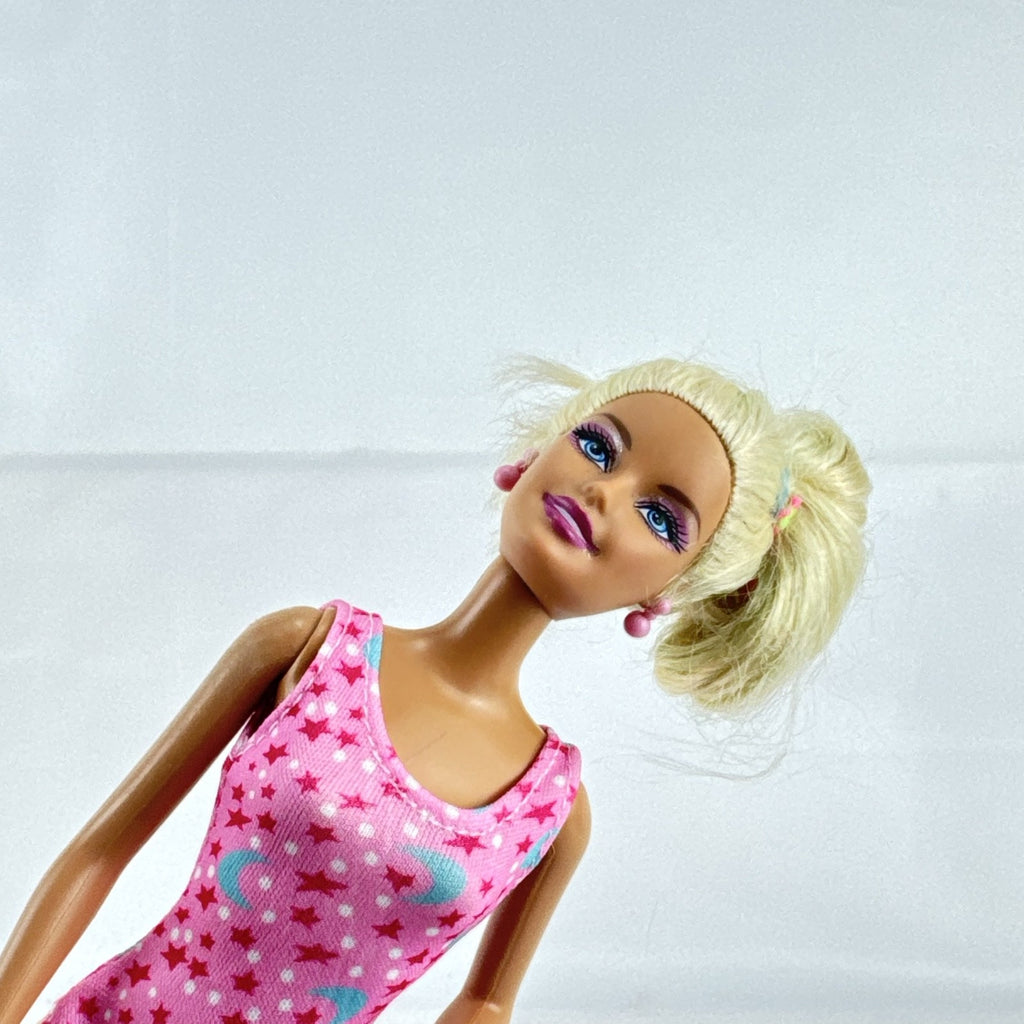 1998 Mattel Barbie doll with blonde side ponytail, celestial star swimsuit, and orange heels