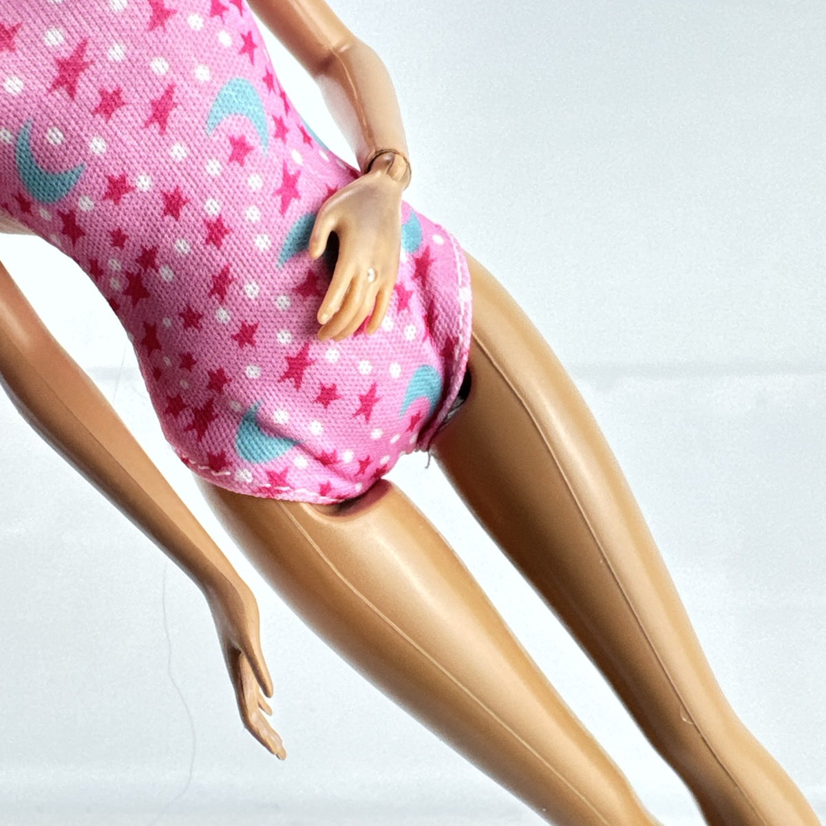 1998 Mattel Barbie doll with blonde side ponytail, celestial star swimsuit, and orange heels