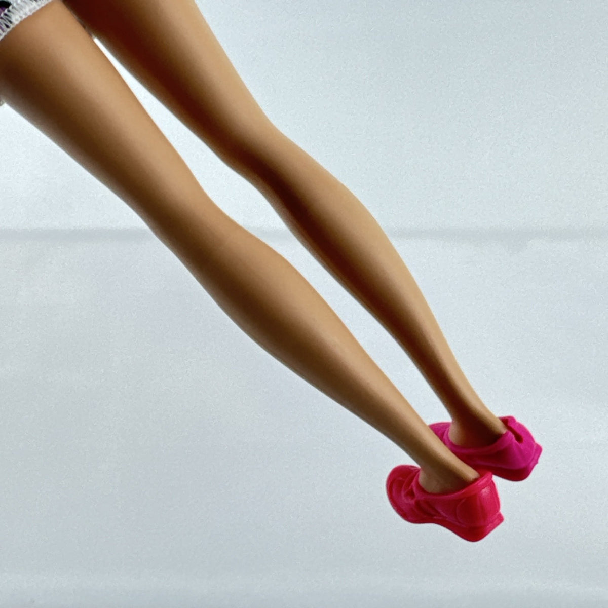 Mattel Barbie Skipper 10-inch doll with purple streaked brown hair in a floral mini dress and pink shoes