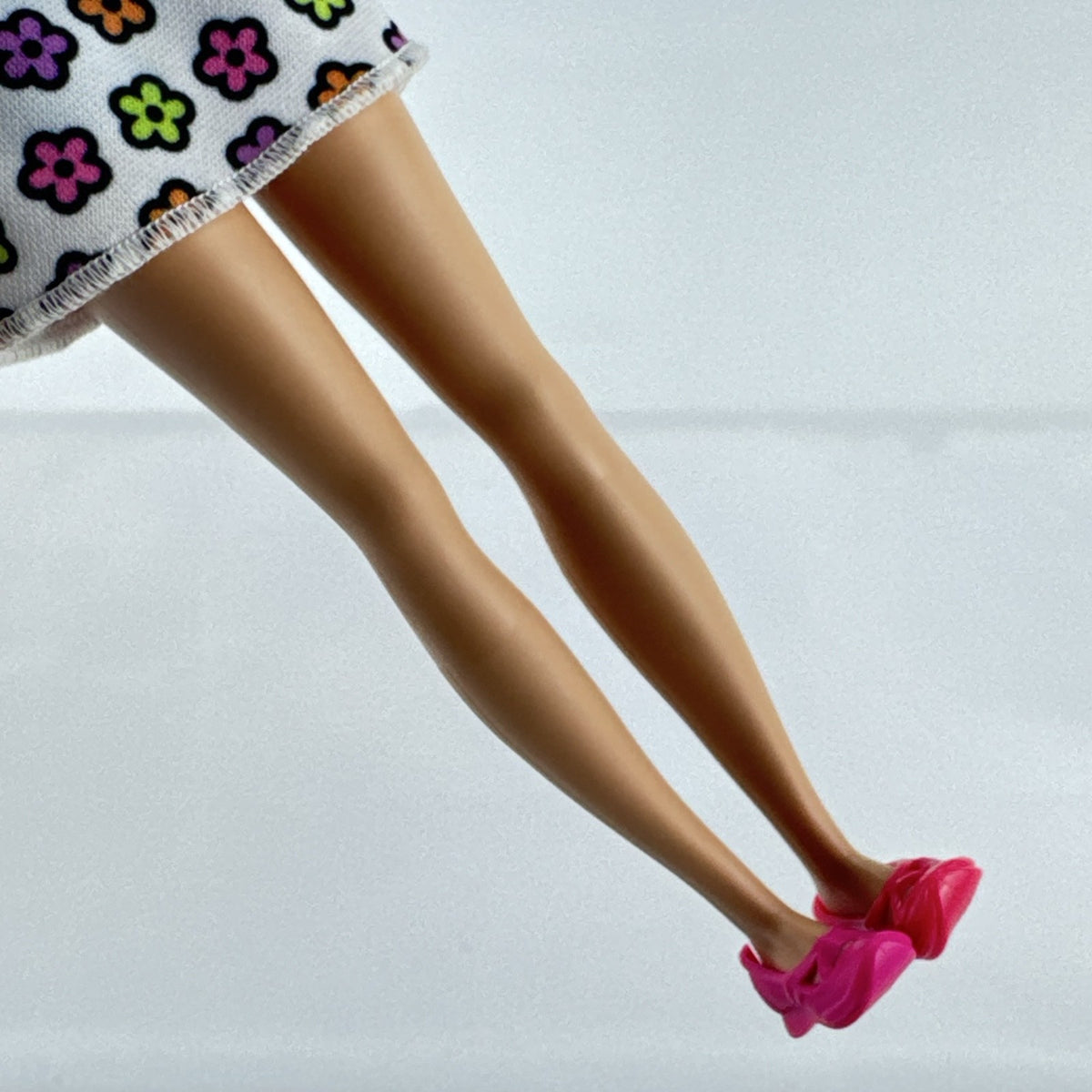 Mattel Barbie Skipper 10-inch doll with purple streaked brown hair in a floral mini dress and pink shoes