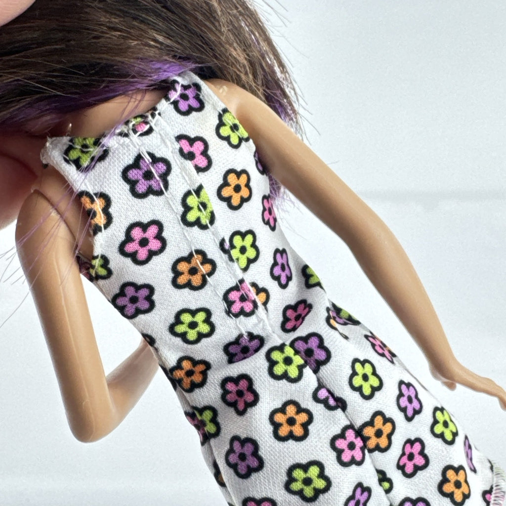 Mattel Barbie Skipper 10-inch doll with purple streaked brown hair in a floral mini dress and pink shoes