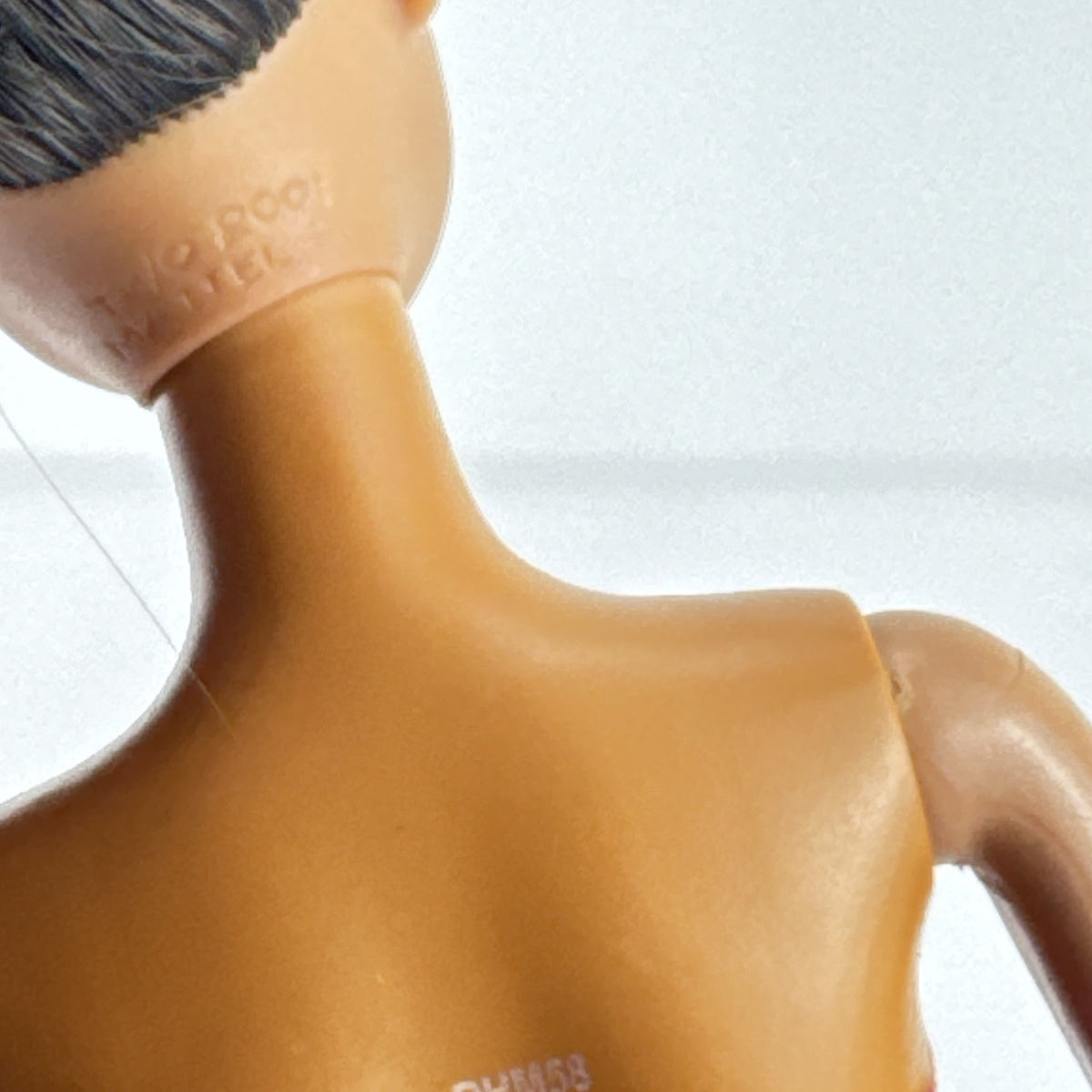 Mattel African American Barbie ballerina doll in molded purple bodice posed on pointe.