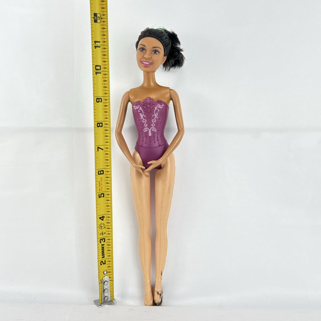 Mattel African American Barbie ballerina doll in molded purple bodice posed on pointe.