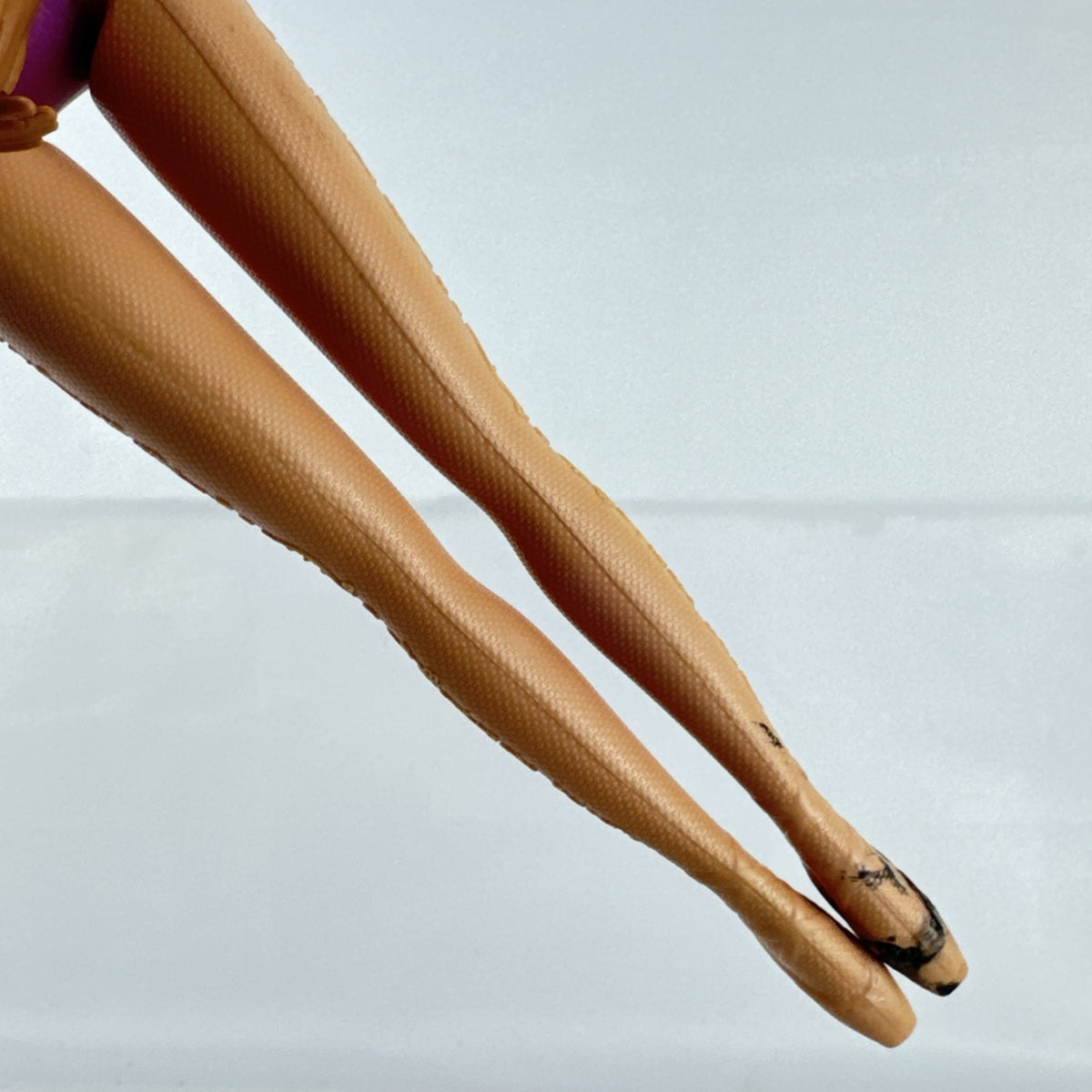 Mattel African American Barbie ballerina doll in molded purple bodice posed on pointe.
