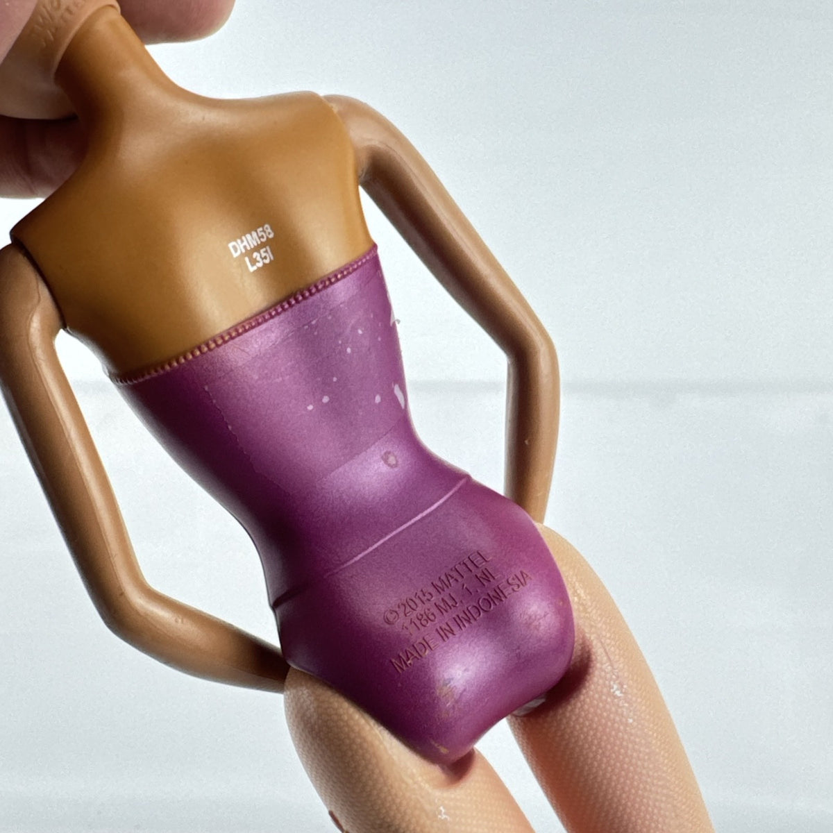 Mattel African American Barbie ballerina doll in molded purple bodice posed on pointe.
