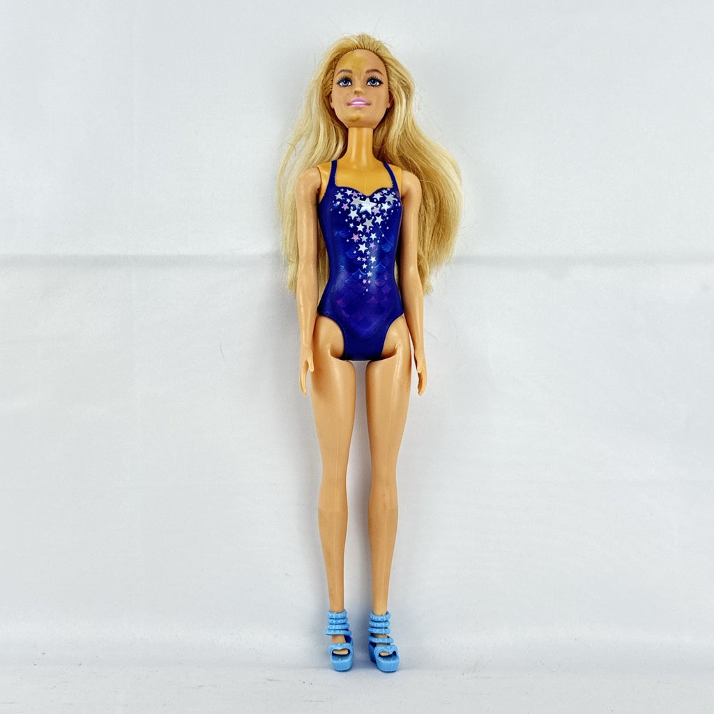 Blonde Mattel Barbie doll wearing a molded blue star swimsuit and matching blue strappy heels