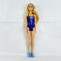 Blonde Mattel Barbie doll wearing a molded blue star swimsuit and matching blue strappy heels