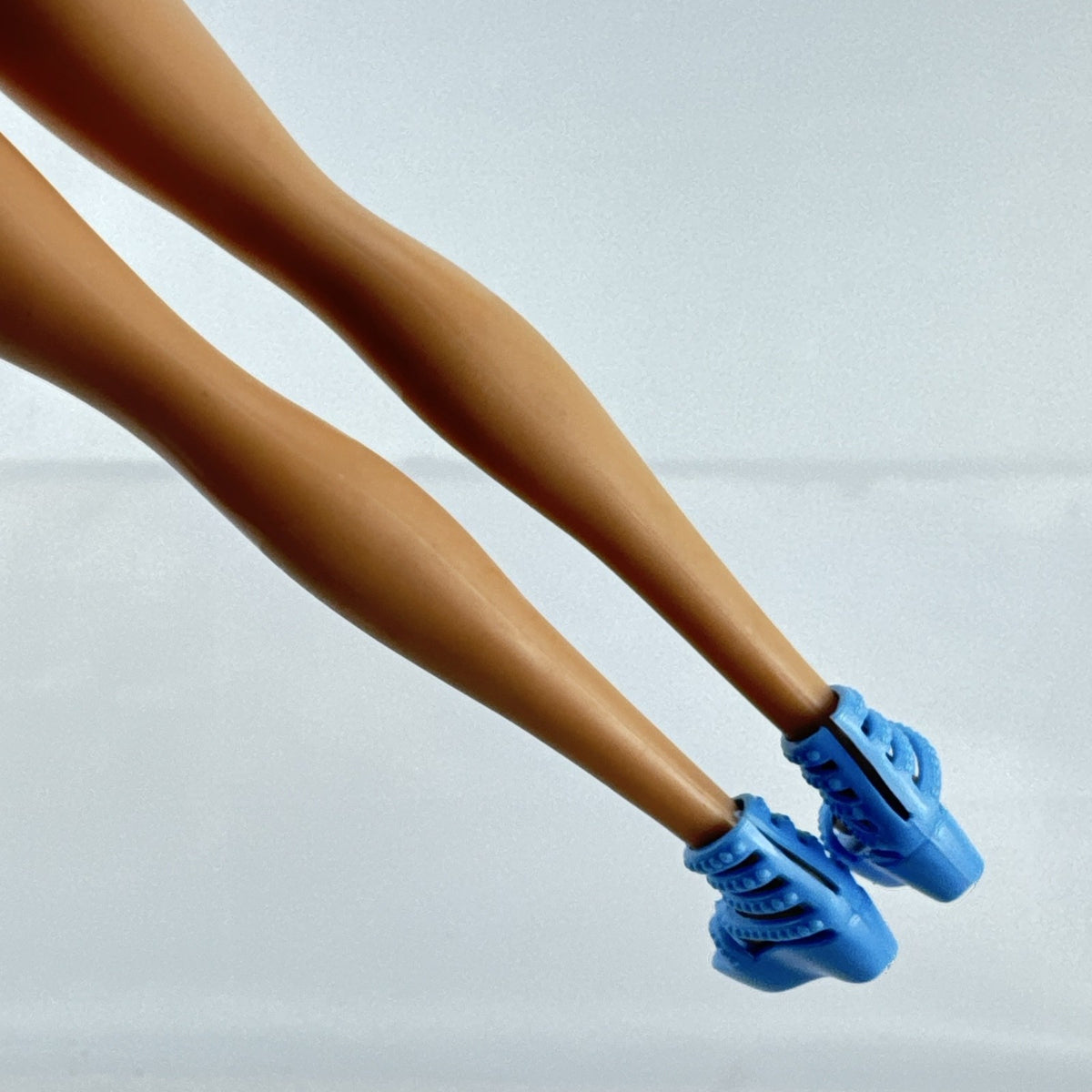 Blonde Mattel Barbie doll wearing a molded blue star swimsuit and matching blue strappy heels