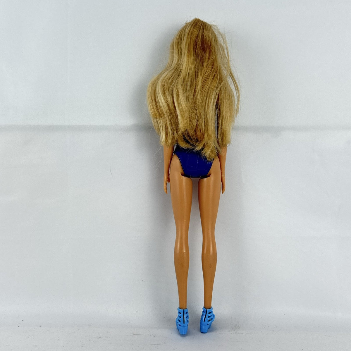 Blonde Mattel Barbie doll wearing a molded blue star swimsuit and matching blue strappy heels