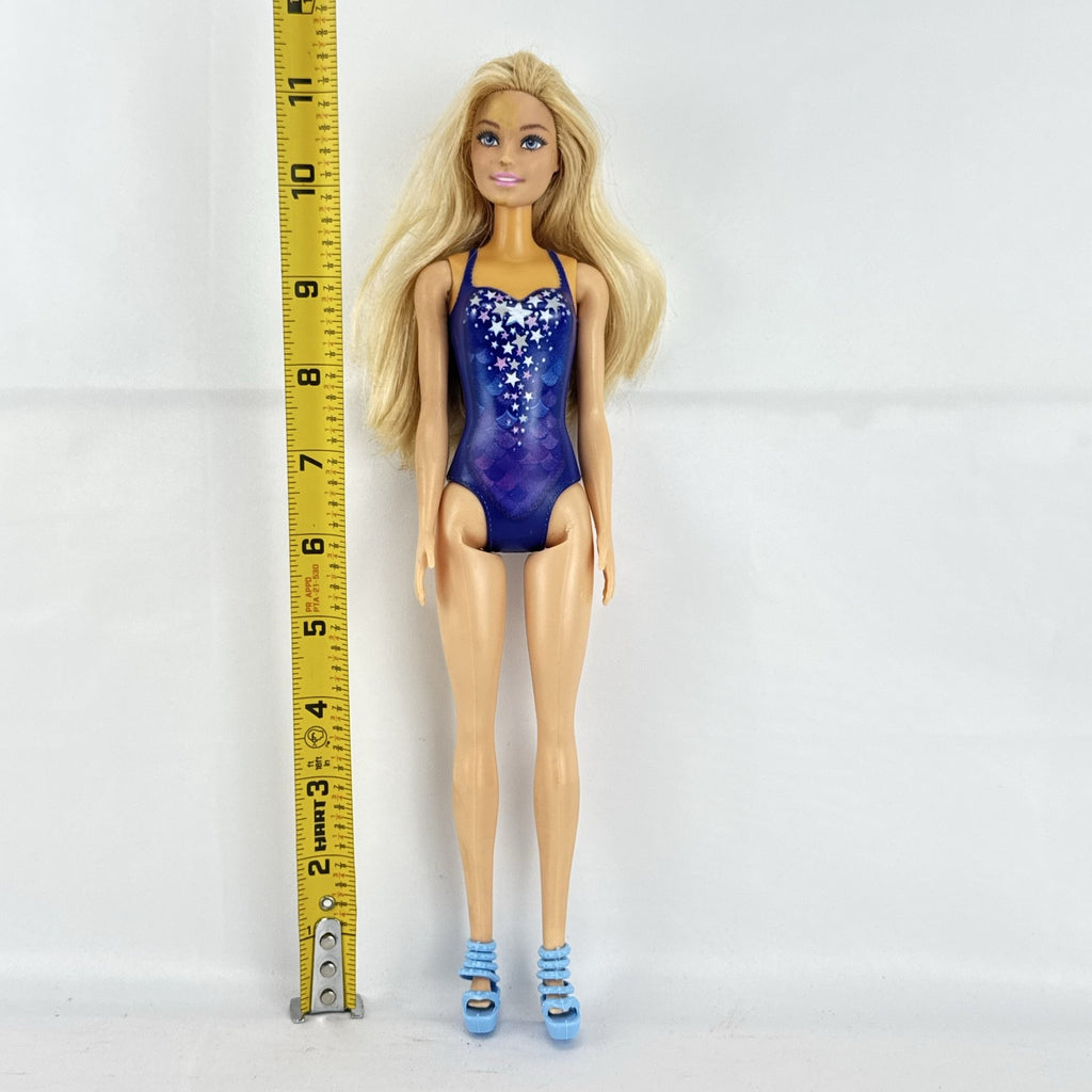 Blonde Mattel Barbie doll wearing a molded blue star swimsuit and matching blue strappy heels