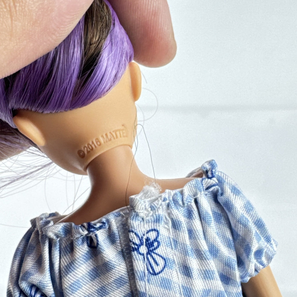 Mattel Barbie Skipper Babysitters Inc doll with purple streaked hair, blue gingham top, and shorts