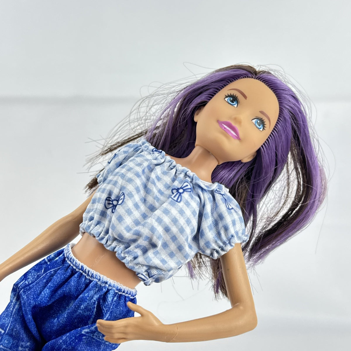 Mattel Barbie Skipper Babysitters Inc doll with purple streaked hair, blue gingham top, and shorts