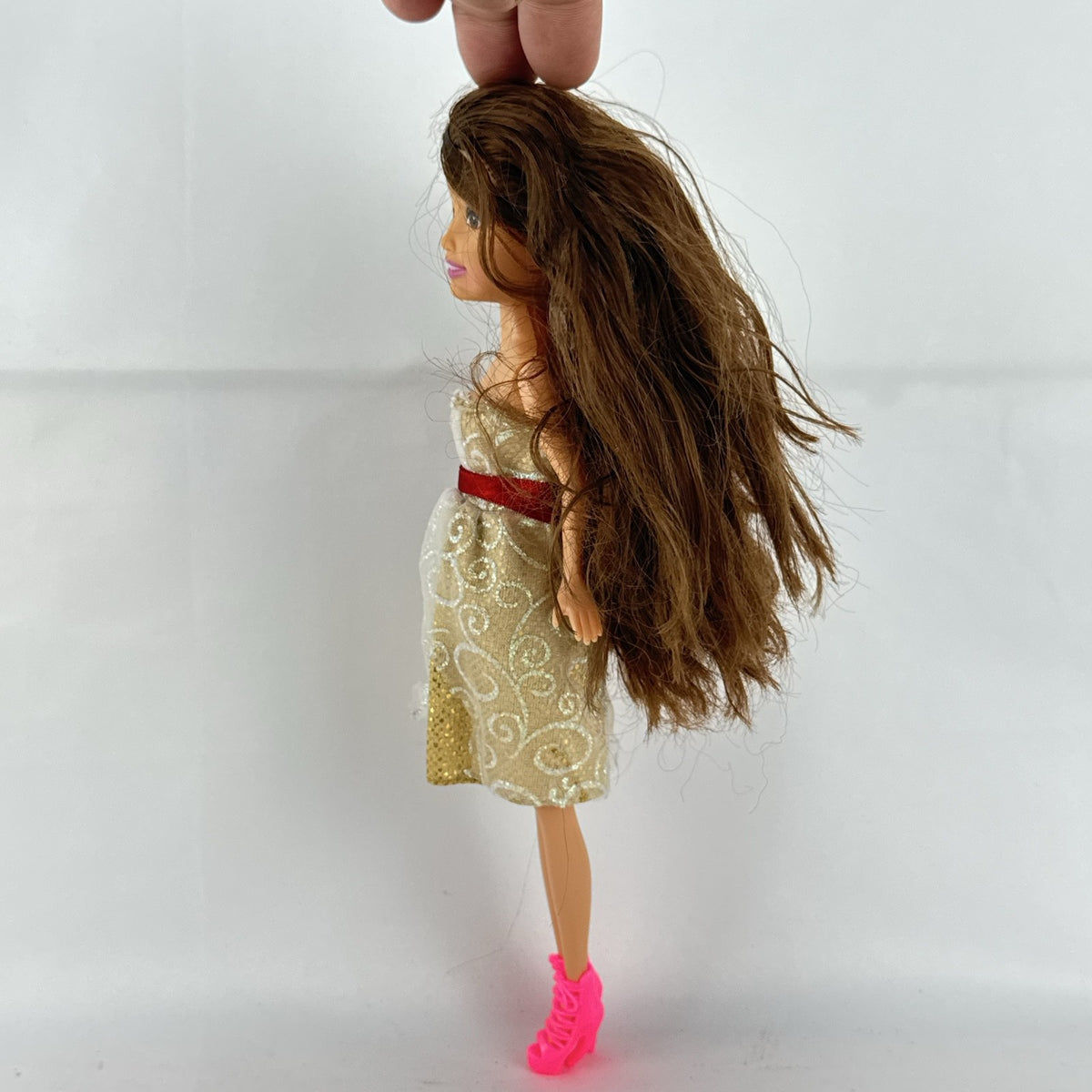 ZURU Sparkle Girlz 10-inch fashion doll with brown hair, cream and gold dress, and bright pink boots