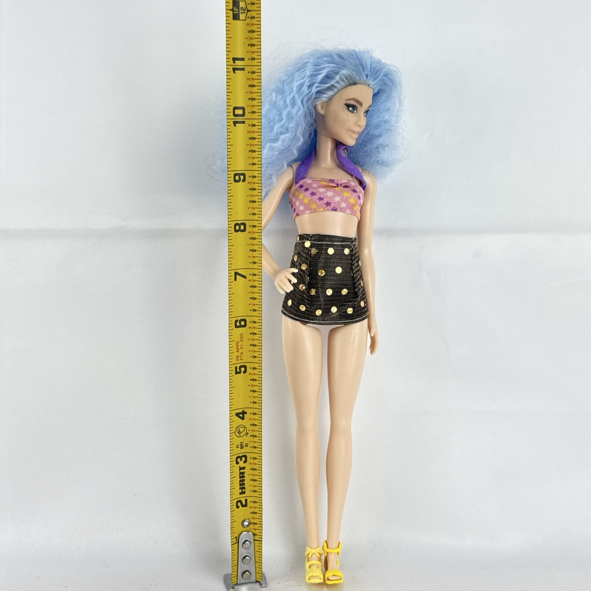Mattel Barbie Fashionistas 12-inch doll with curly light blue hair, halter crop top, and gold sequin skirt