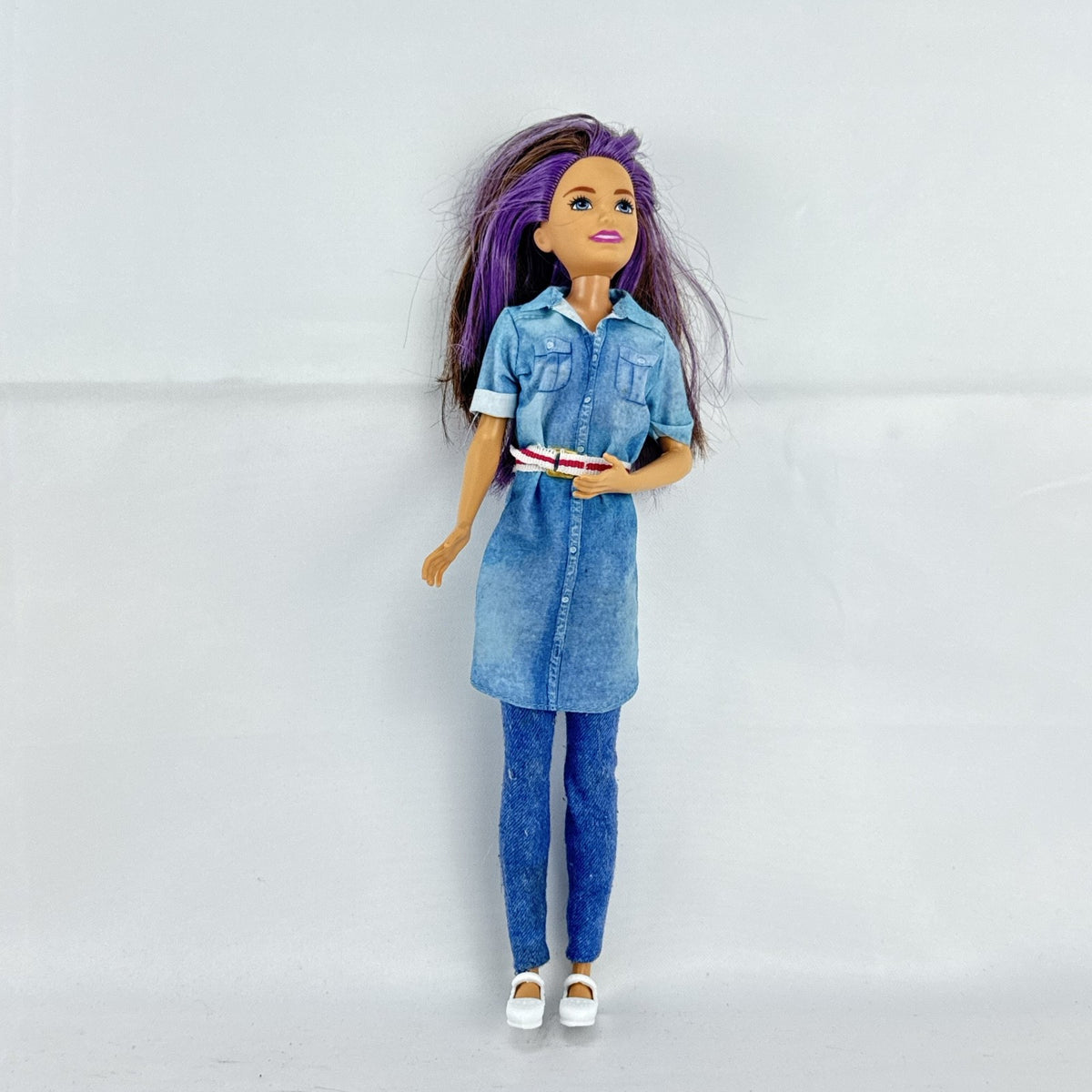Mattel Barbie Dreamhouse Adventures Skipper doll with purple hair in denim tunic and white shoes