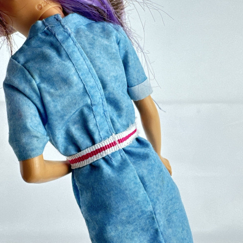 Mattel Barbie Dreamhouse Adventures Skipper doll with purple hair in denim tunic and white shoes