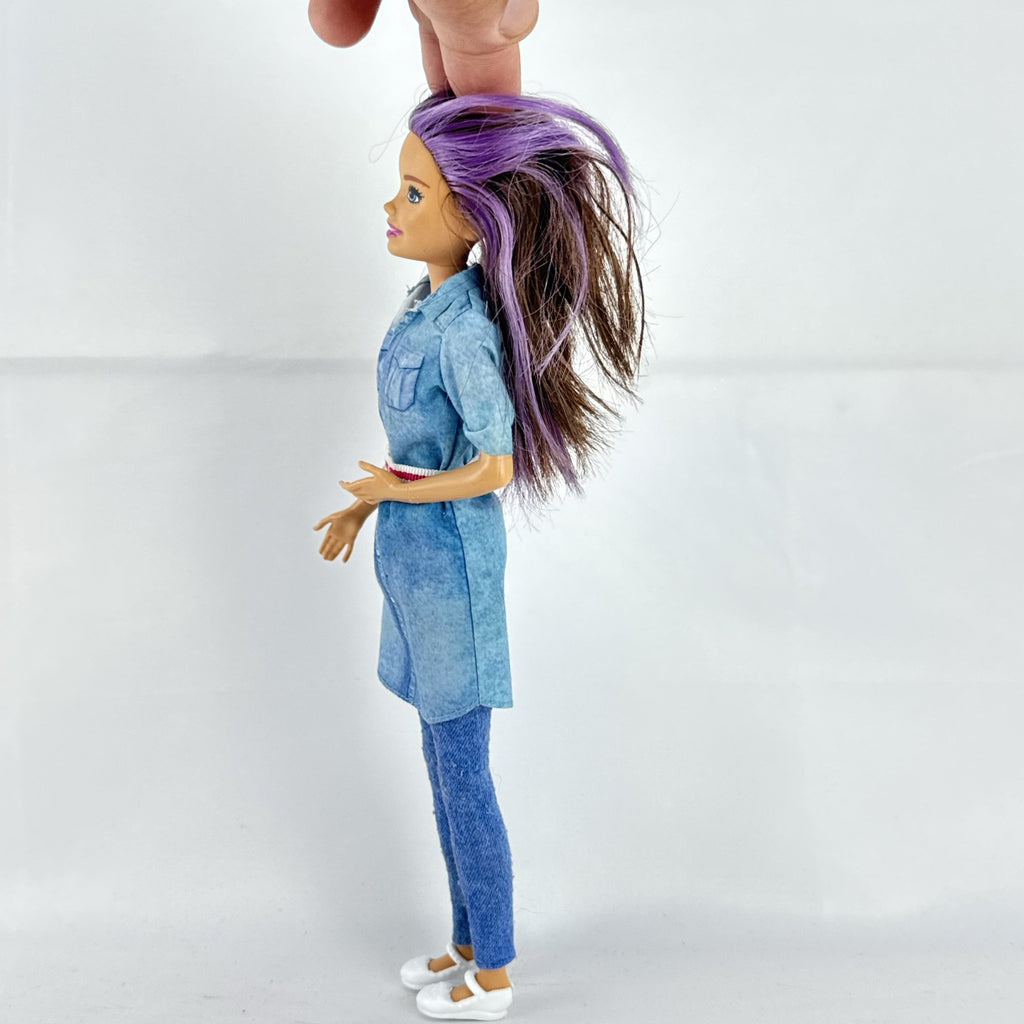 Mattel Barbie Dreamhouse Adventures Skipper doll with purple hair in denim tunic and white shoes