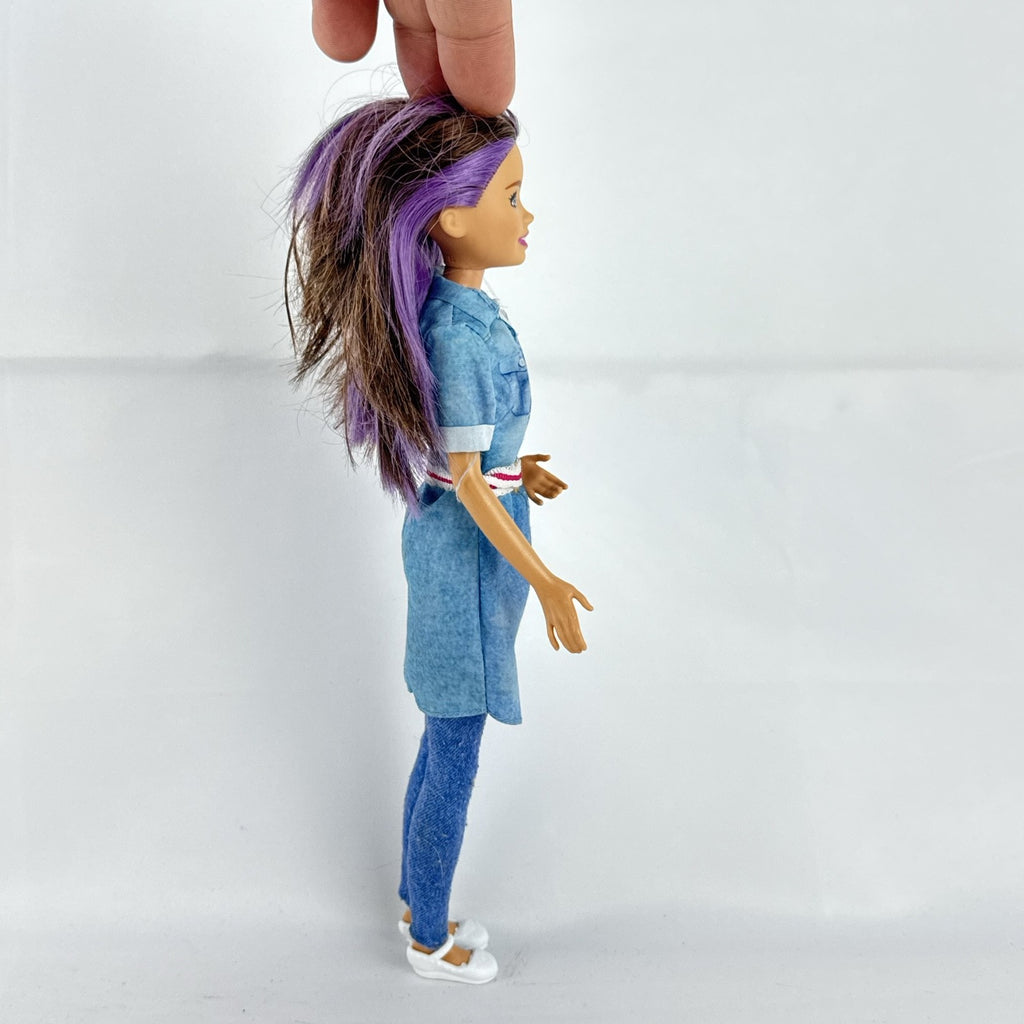 Mattel Barbie Dreamhouse Adventures Skipper doll with purple hair in denim tunic and white shoes