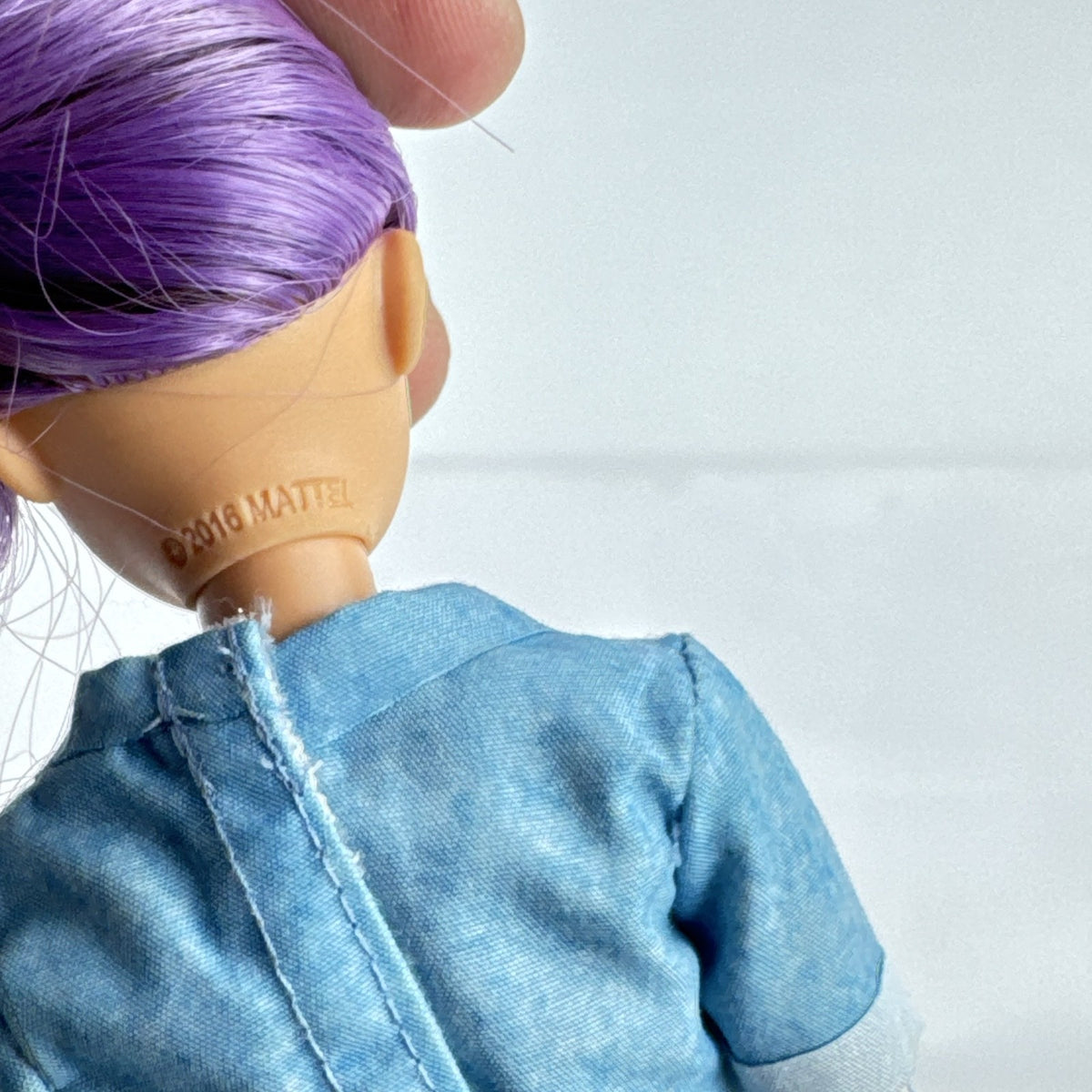 Mattel Barbie Dreamhouse Adventures Skipper doll with purple hair in denim tunic and white shoes