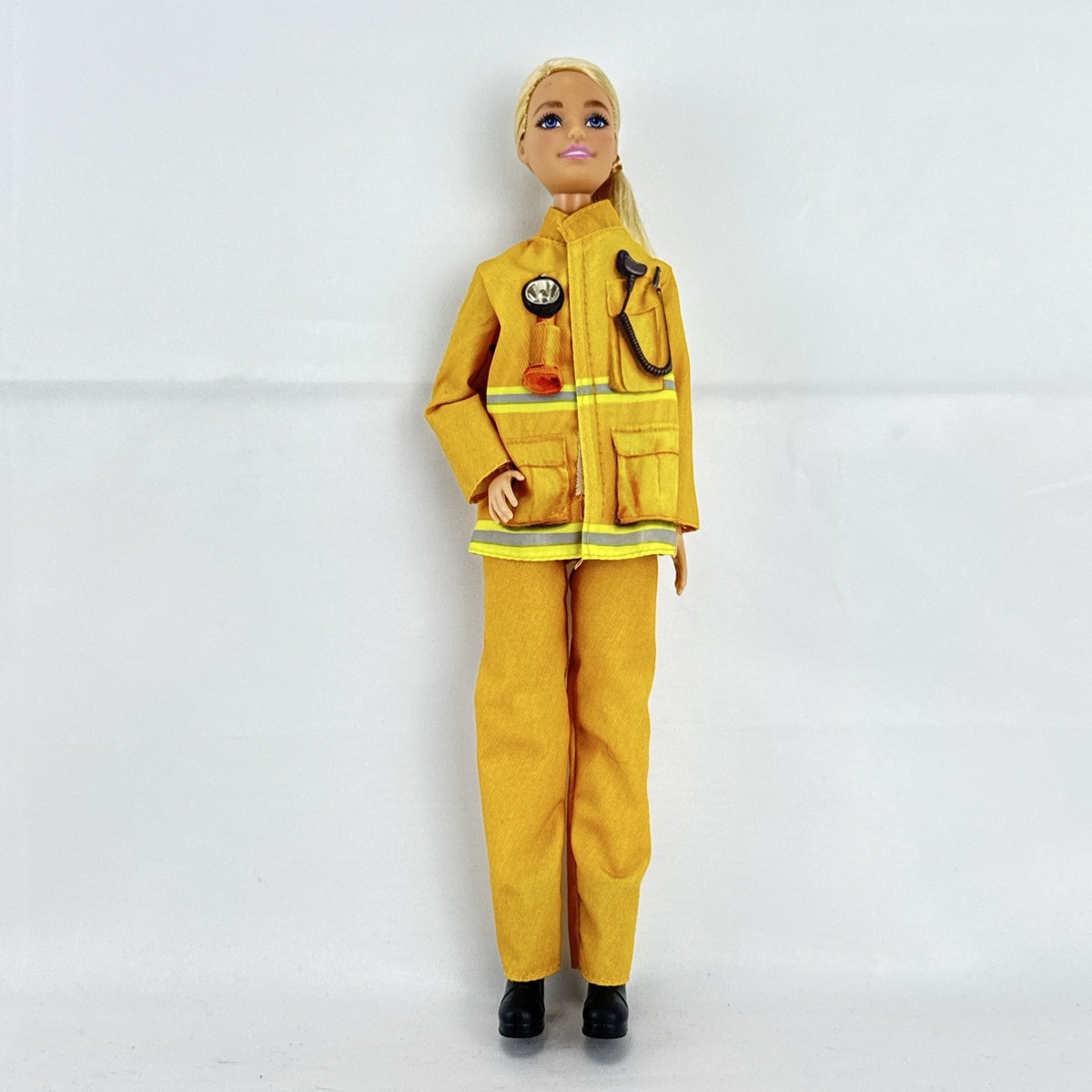 Mattel Barbie Careers blonde firefighter doll wearing yellow rescue suit and black boots