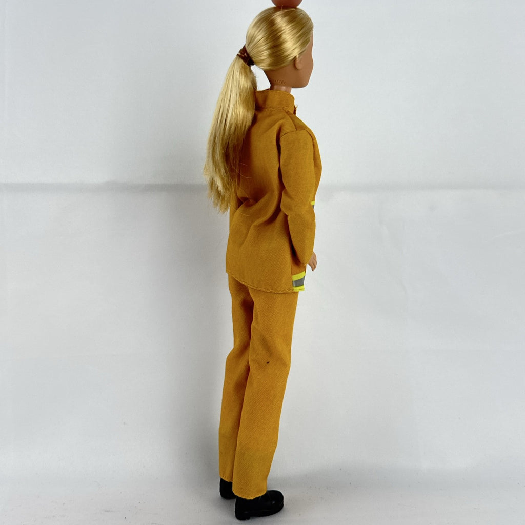 Mattel Barbie Careers blonde firefighter doll wearing yellow rescue suit and black boots