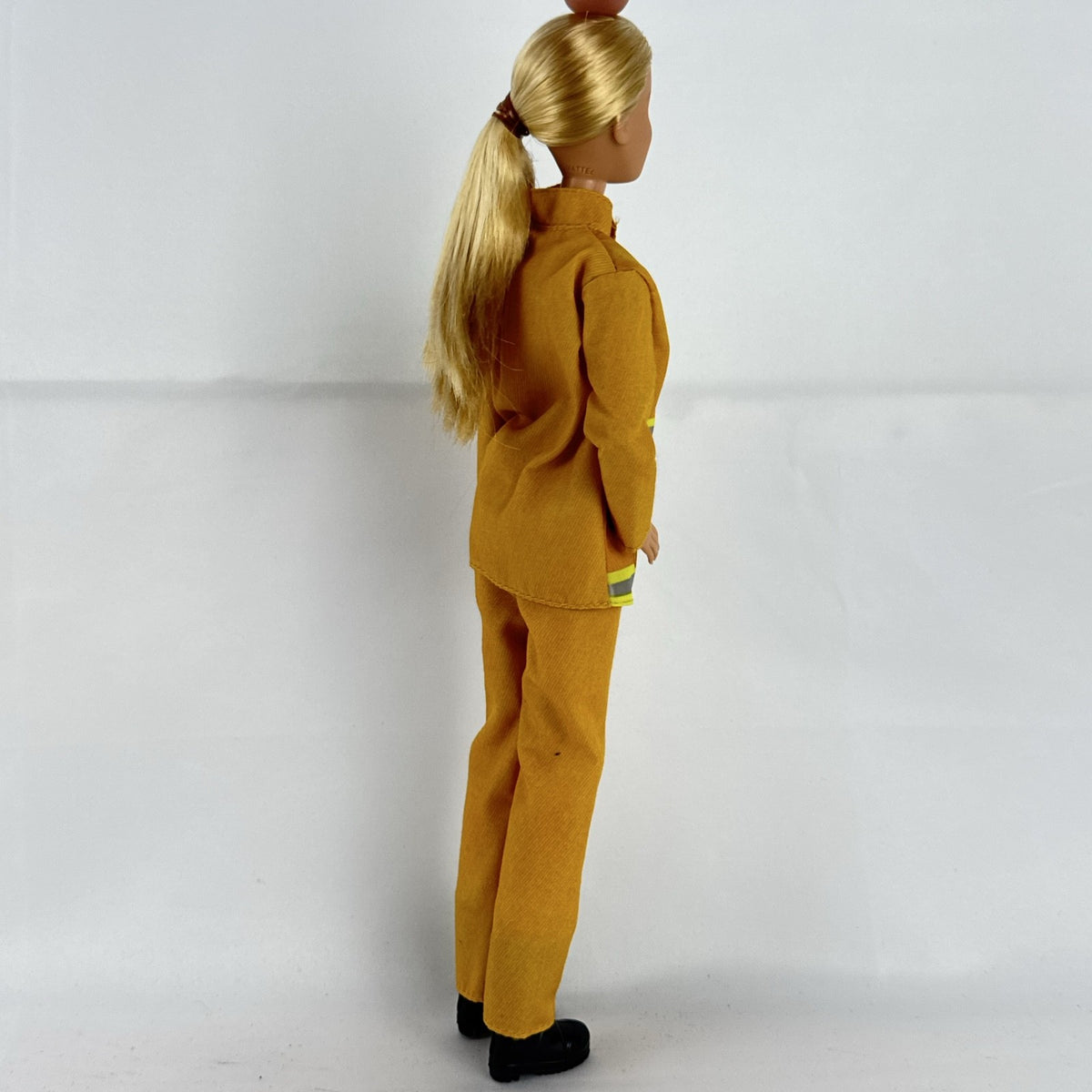 Mattel Barbie Careers blonde firefighter doll wearing yellow rescue suit and black boots