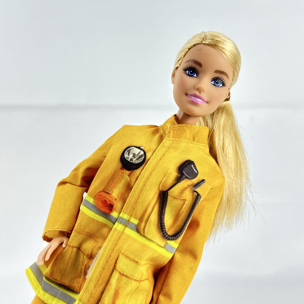 Mattel Barbie Careers blonde firefighter doll wearing yellow rescue suit and black boots