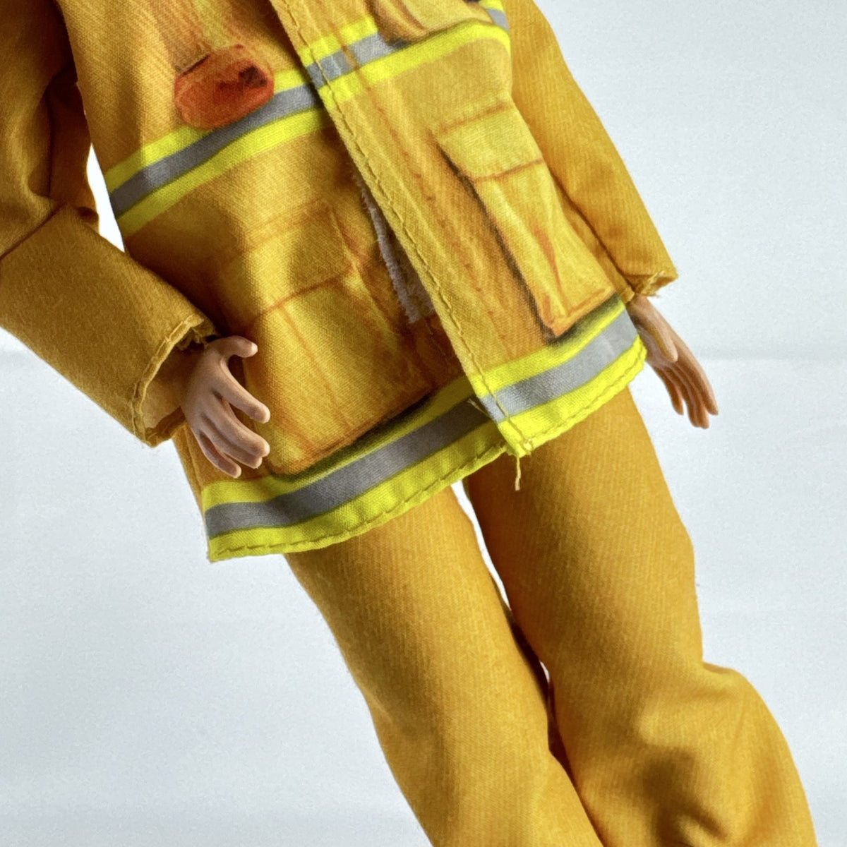 Mattel Barbie Careers blonde firefighter doll wearing yellow rescue suit and black boots