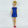 Mattel Barbie Careers teacher doll with blonde hair bun wearing a blue alphabet dress and pink shoes