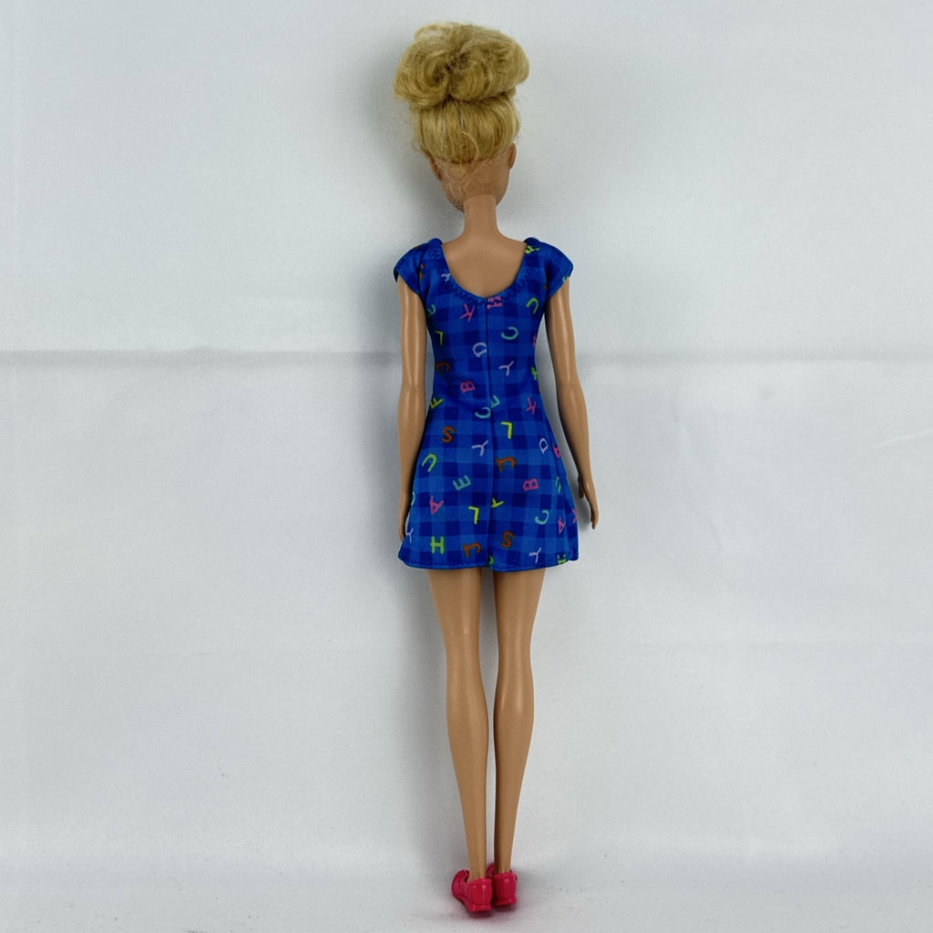 Mattel Barbie Careers teacher doll with blonde hair bun wearing a blue alphabet dress and pink shoes
