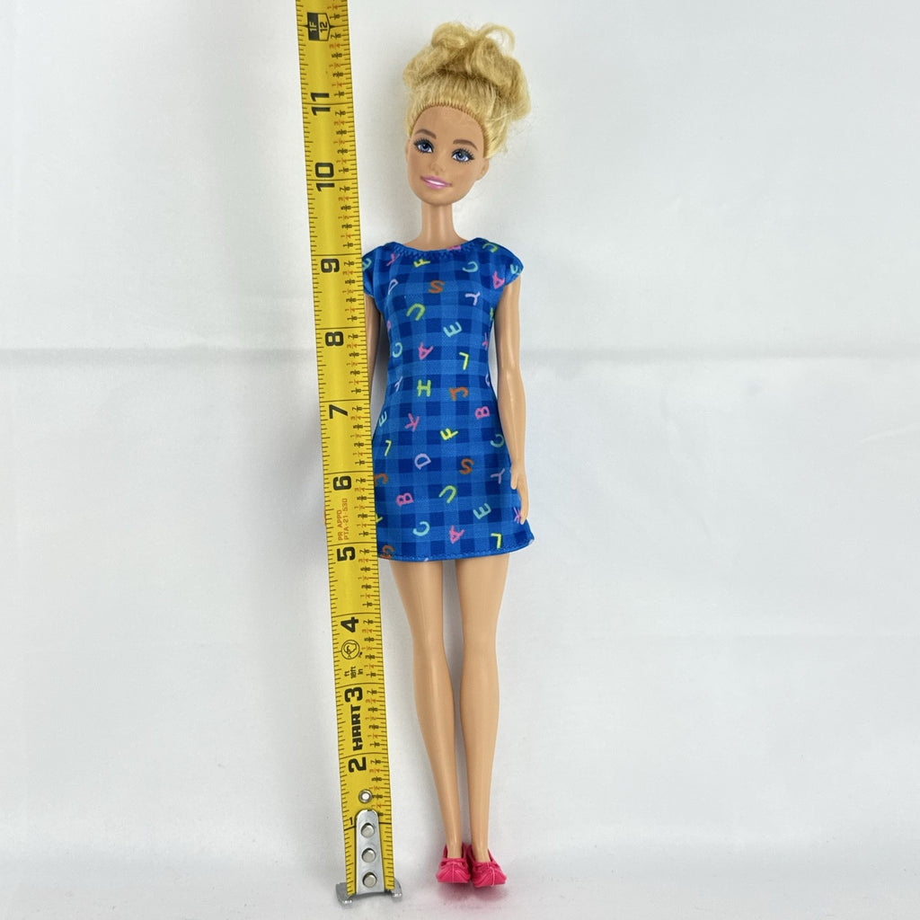 Mattel Barbie Careers teacher doll with blonde hair bun wearing a blue alphabet dress and pink shoes