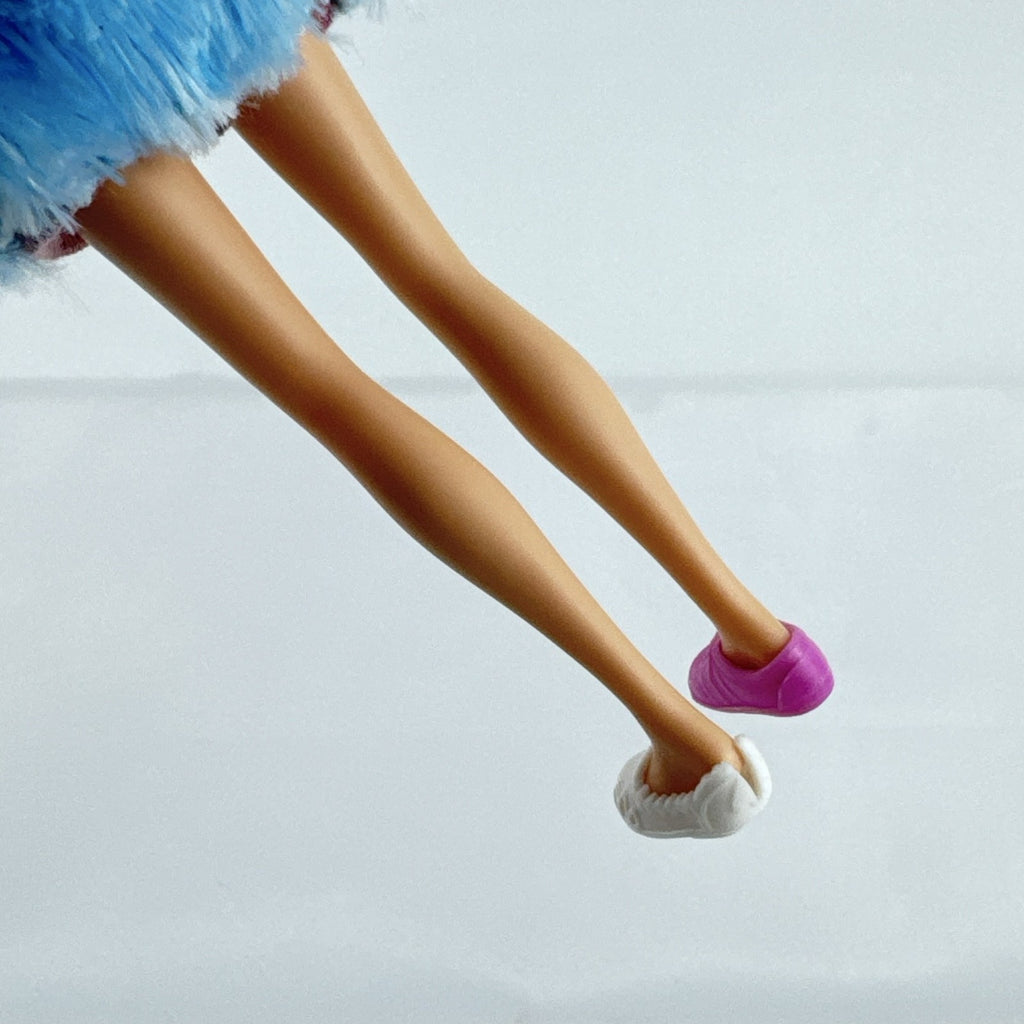 Just Play Hairdorables Hairmazing Harmony fashion doll with purple hair, floral romper, and light blue faux fur vest