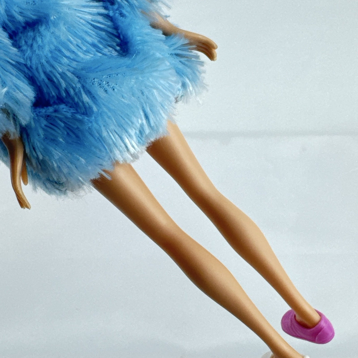 Just Play Hairdorables Hairmazing Harmony fashion doll with purple hair, floral romper, and light blue faux fur vest