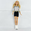 Mattel Barbie blonde ice skater doll with articulated knees wearing a striped athletic outfit and white skates