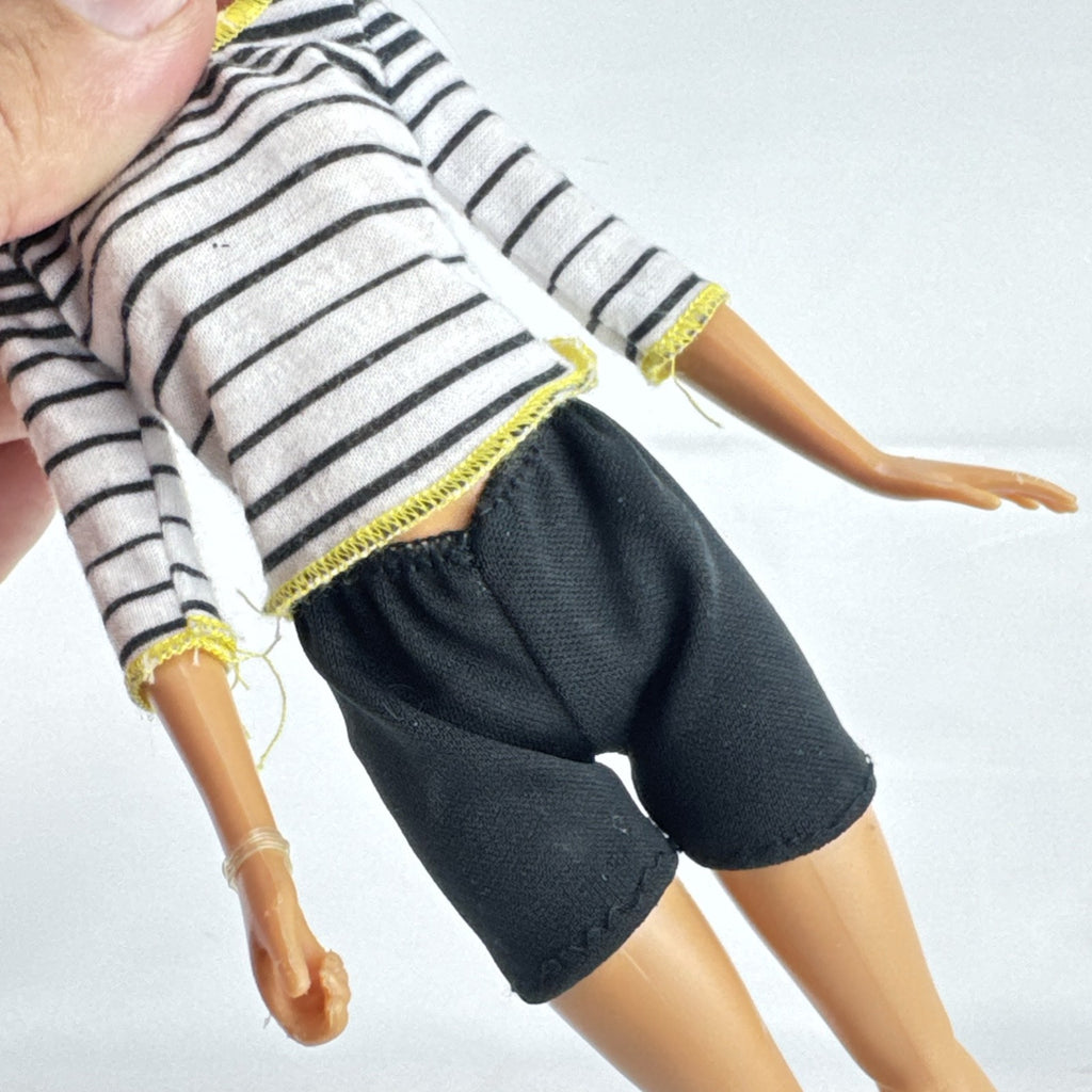 Mattel Barbie blonde ice skater doll with articulated knees wearing a striped athletic outfit and white skates