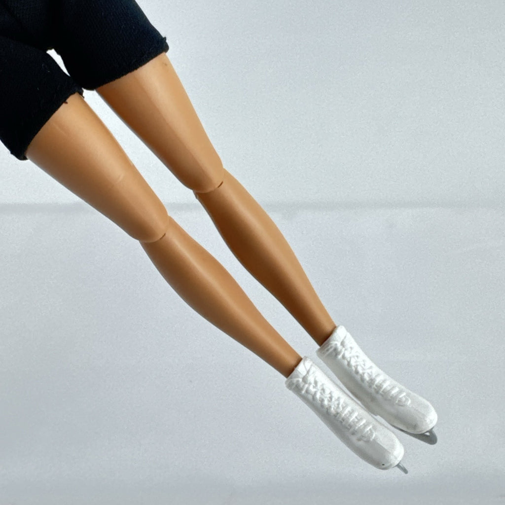 Mattel Barbie blonde ice skater doll with articulated knees wearing a striped athletic outfit and white skates
