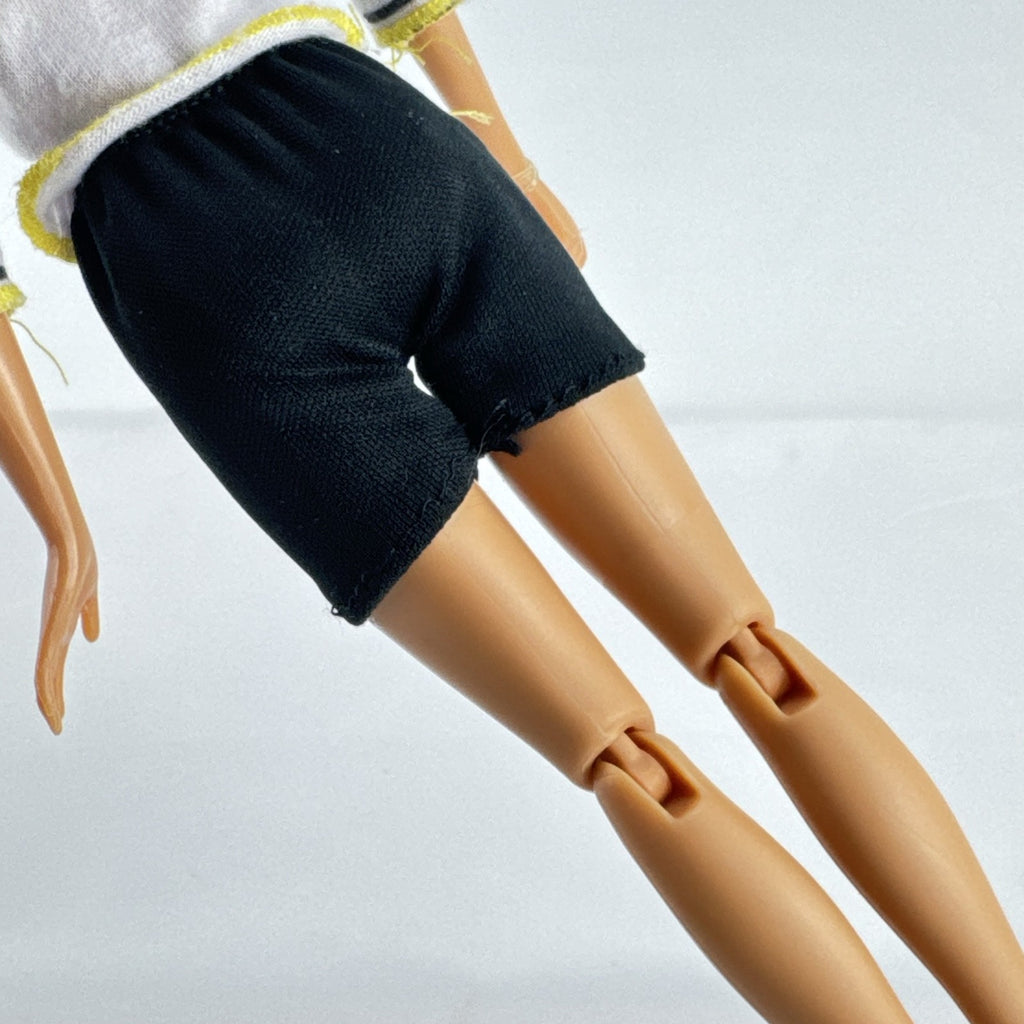 Mattel Barbie blonde ice skater doll with articulated knees wearing a striped athletic outfit and white skates