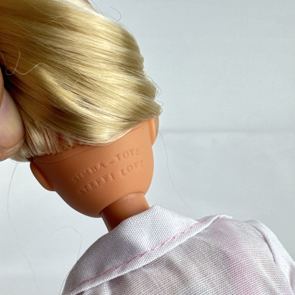 Simba Steffi Love blonde doctor doll wearing a white lab coat and pink knit dress