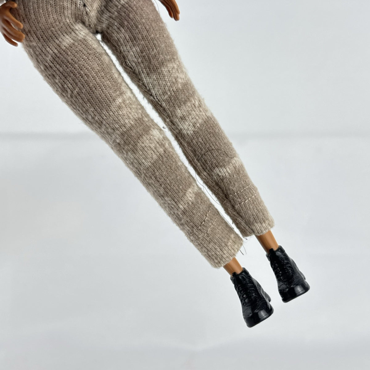 Mattel Barbie Fashionistas doll with topknot bun, wearing a heathered knit two-piece outfit and black ankle boots.