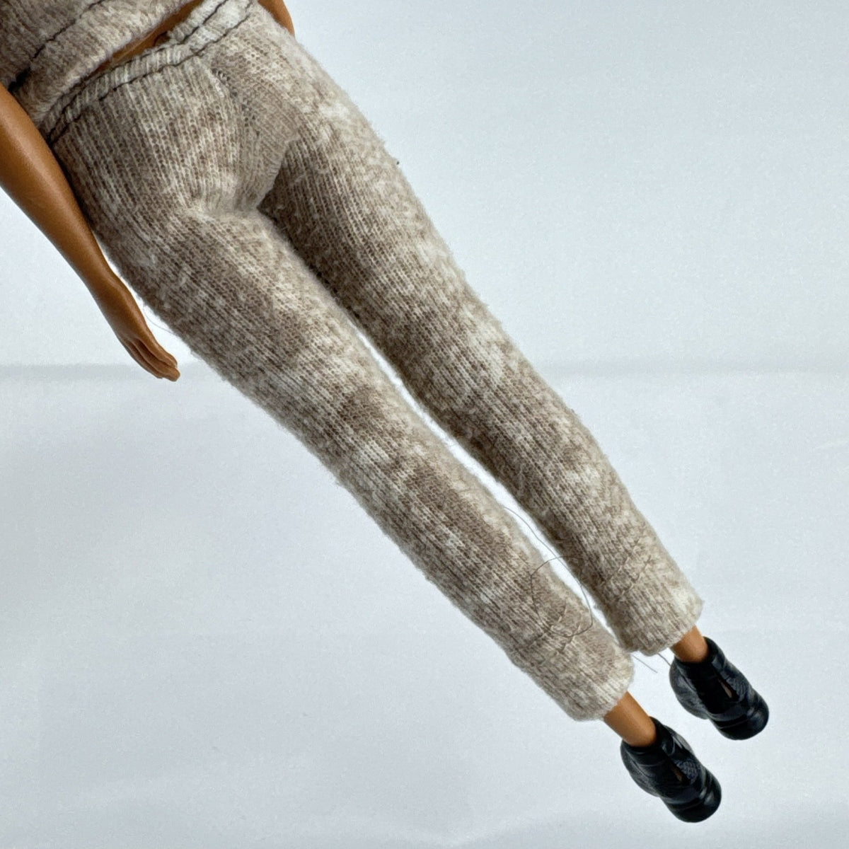 Mattel Barbie Fashionistas doll with topknot bun, wearing a heathered knit two-piece outfit and black ankle boots.